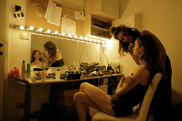 model get make-up done backstage before video shooting